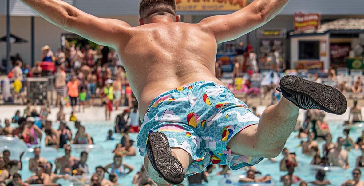 Father jumping in pool